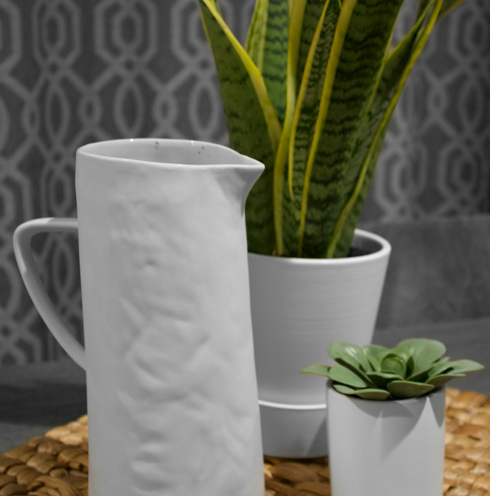 white ceramic mug on brown table