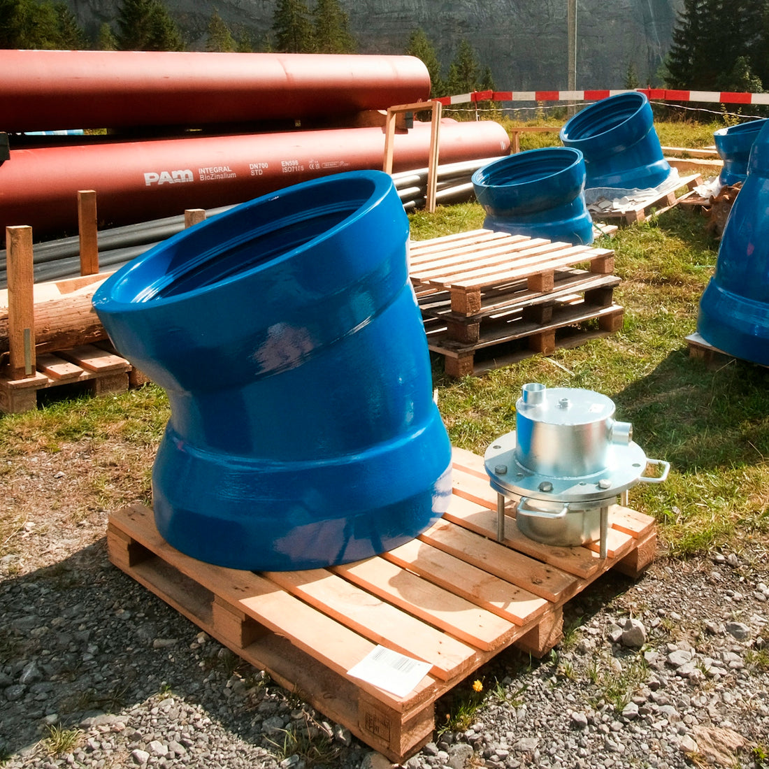 a group of blue and orange water tanks on a wooden bench