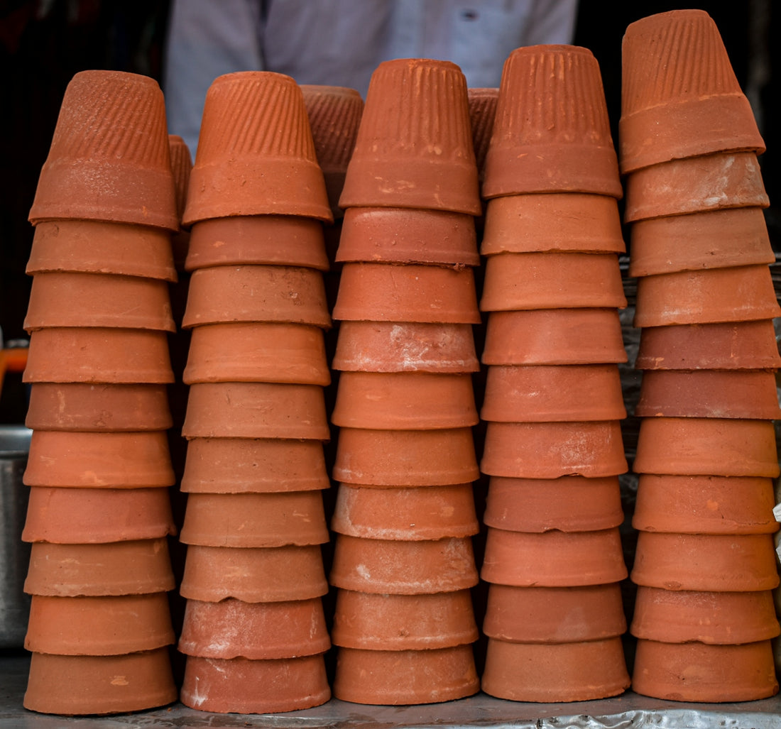a bunch of clay pots stacked on top of each other